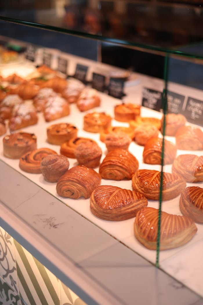 Enticing variety of pastries in a bakery display, perfect for a sweet treat.